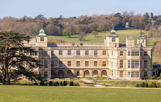 A view of Audley End from a far on a sunny day.