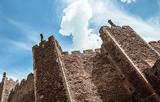 Looking up at tall castle walls