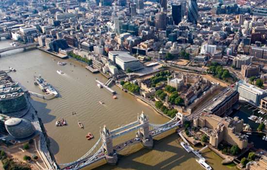 An aerial view of the River Thames, with view of Tower Bridge.